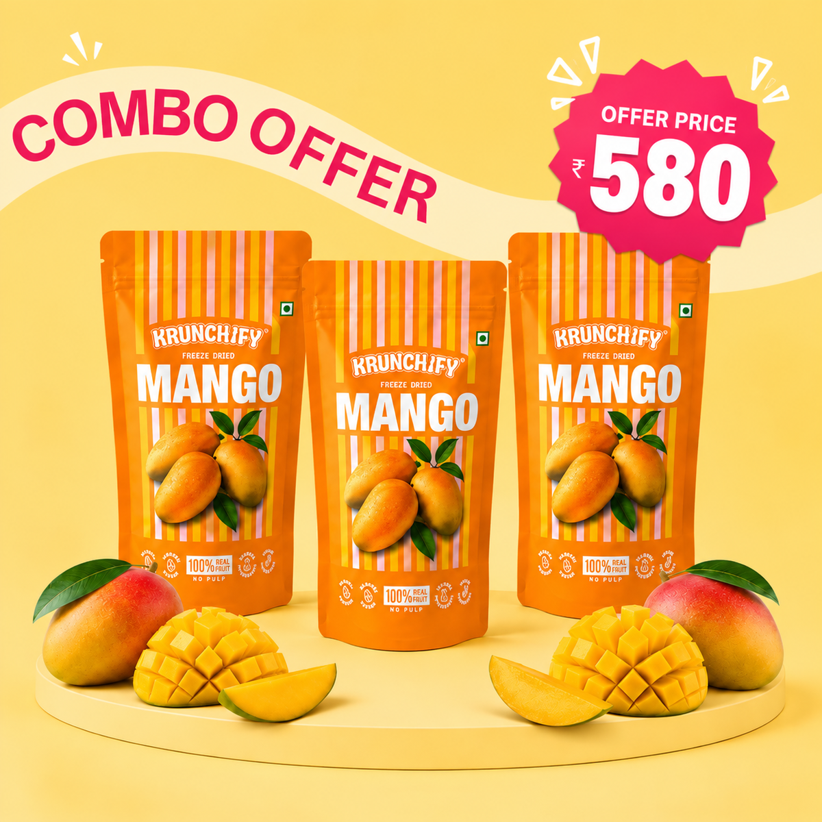 Three stand-up pouches of Krunchify Freeze-Dried Mango are arranged on a round platform with mango slices and whole mangoes around them. A curved banner reads 'COMBO OFFER' and a pink starburst says 'OFFER PRICE 580'.
