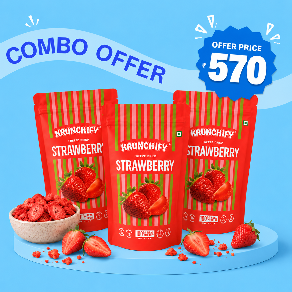 Three red bags of Krunchify Freeze-Dried Strawberry are displayed on a light blue background with promotional text 'COMBO OFFER' and 'OFFER PRICE 570'. A small bowl of dried strawberry pieces and loose strawberries are placed in front of the bags.